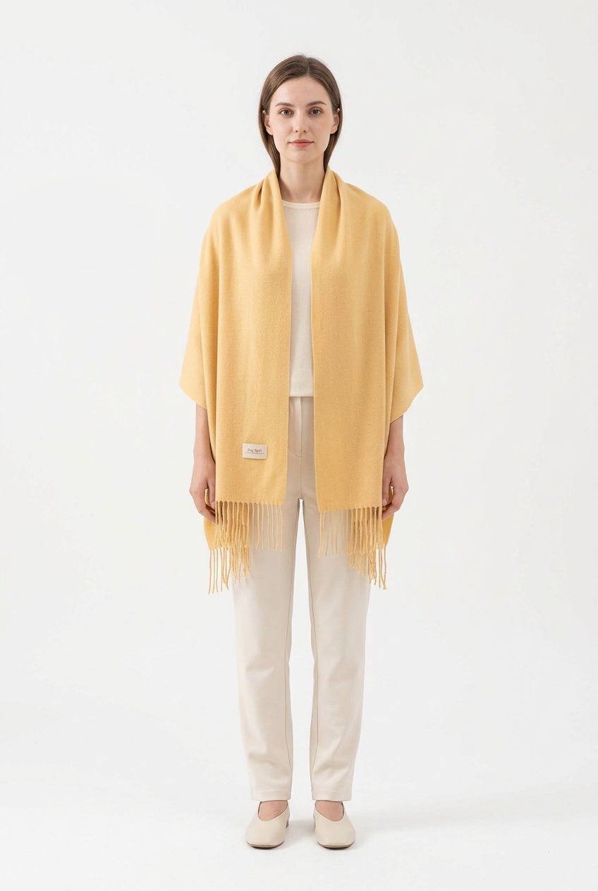 Light Yellow fringed scarf styled as a wrap on a full-length model