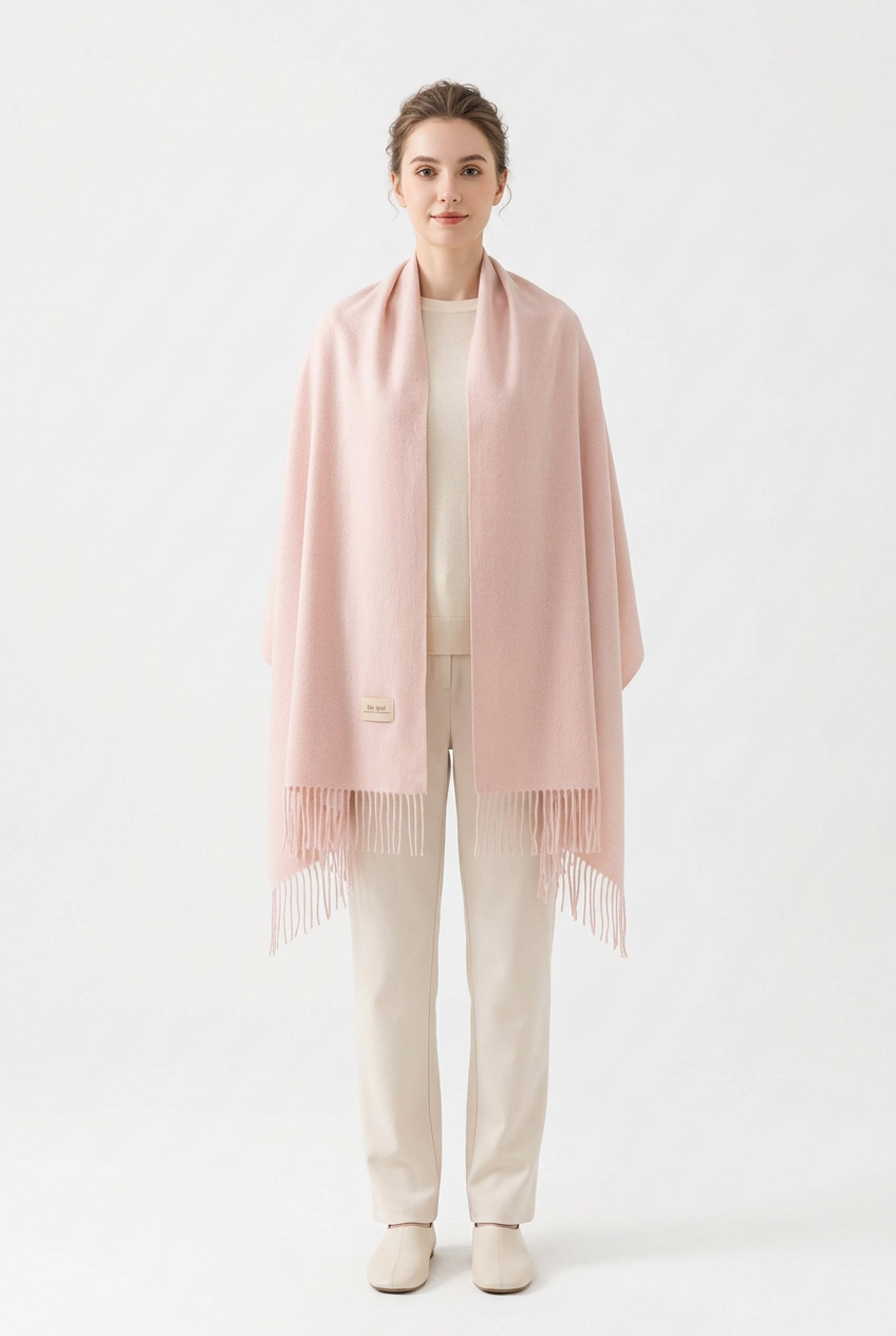 Light Pink fringed scarf styled as a shoulder wrap on a full-length model