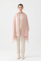 Light Pink fringed scarf styled as a shoulder wrap on a full-length model